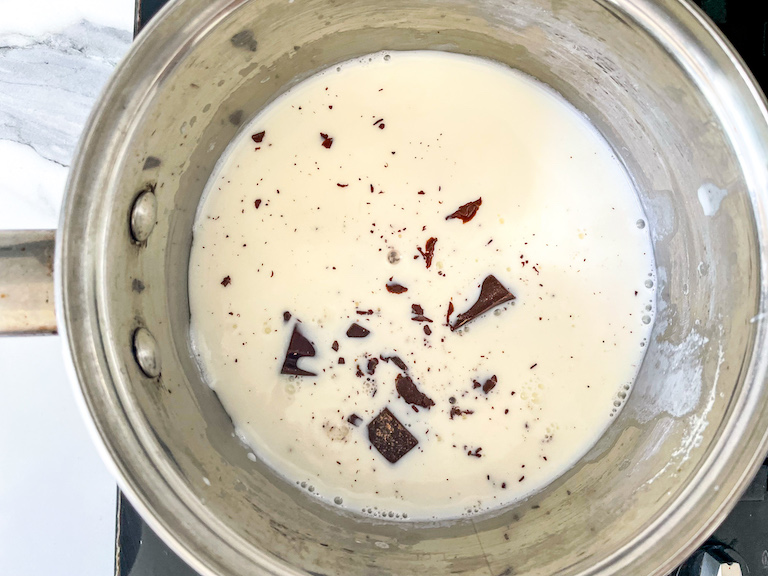 Chocolate and warm milk in a pan