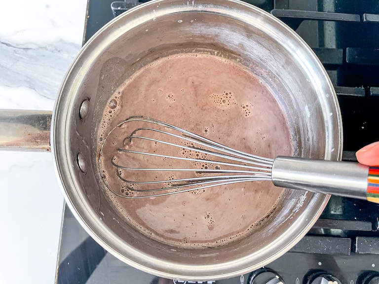 Whisking homemade hot chocolate in a pan