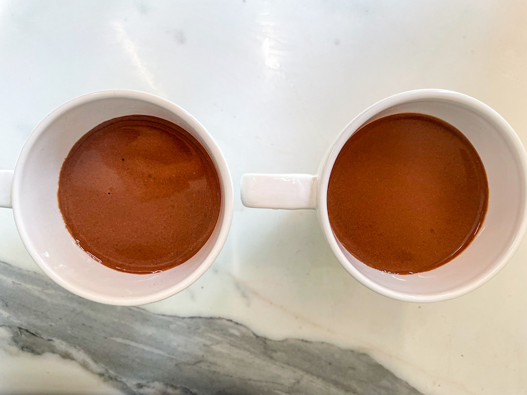 Two mugs of raspberry rose hot chocolate