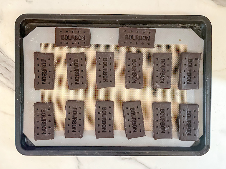 Unbaked bourbon cream biscuits on a tray