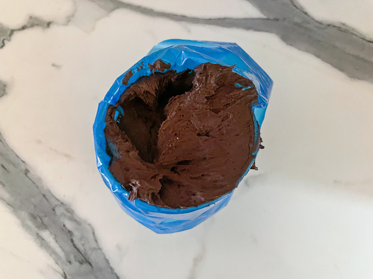 A piping bag of chocolate buttercream