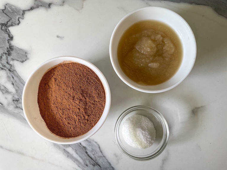 Bowls of applesauce, ground cinnamon, and salt