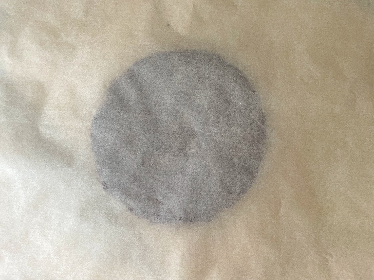 Cinnamon ornament dough between sheets of parchment