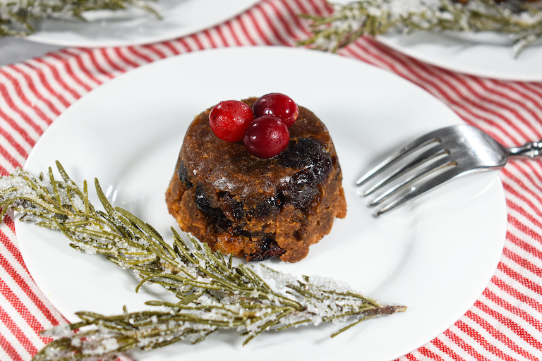 A mini Christmas pudding on a white plate