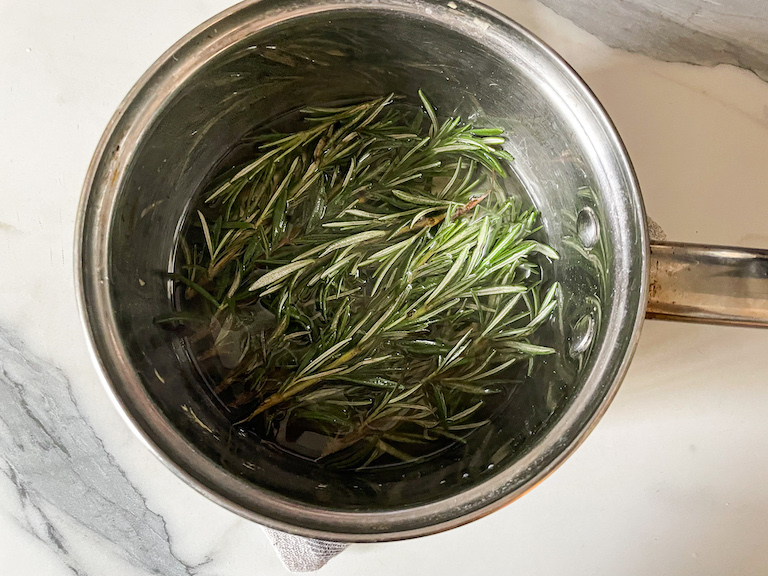 Rosemary and syrup in a pan