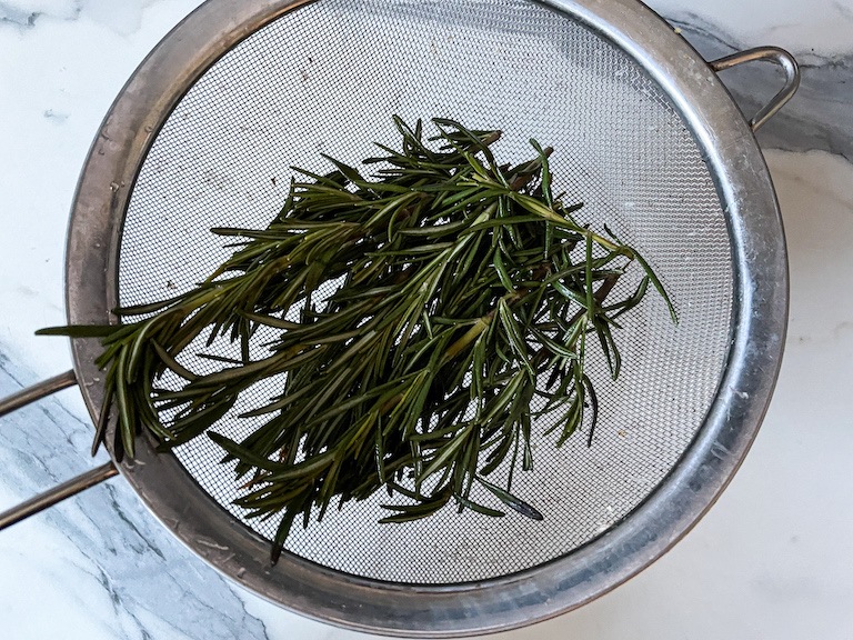 Rosemary in a fine mesh strainer