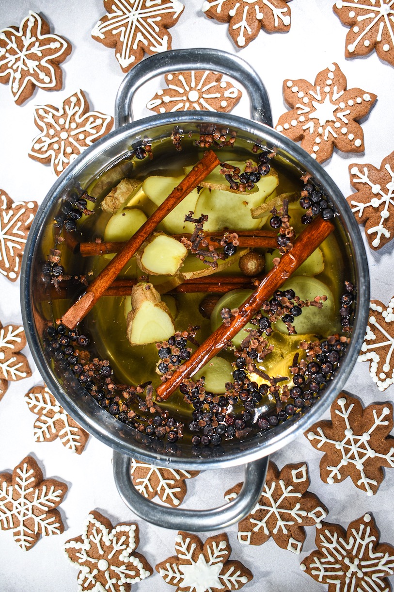 a gingerbread simmer pot surrounded by gingerbread cookies