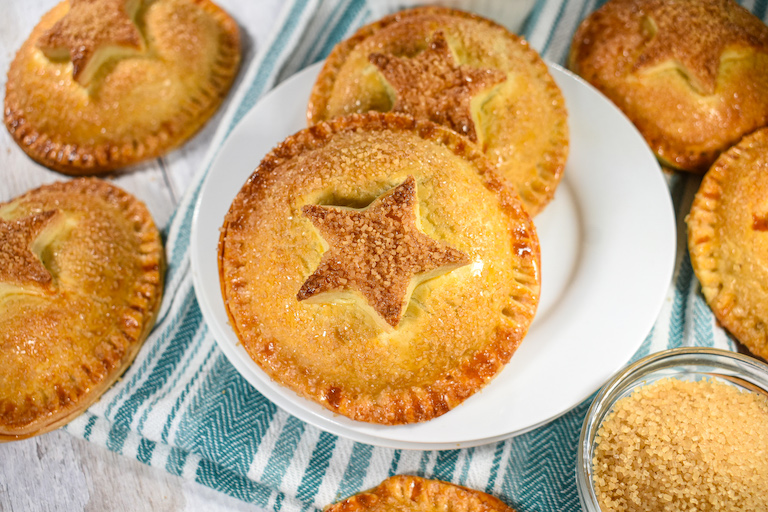 Horizontal shot of mince pie hand pies on a white plate