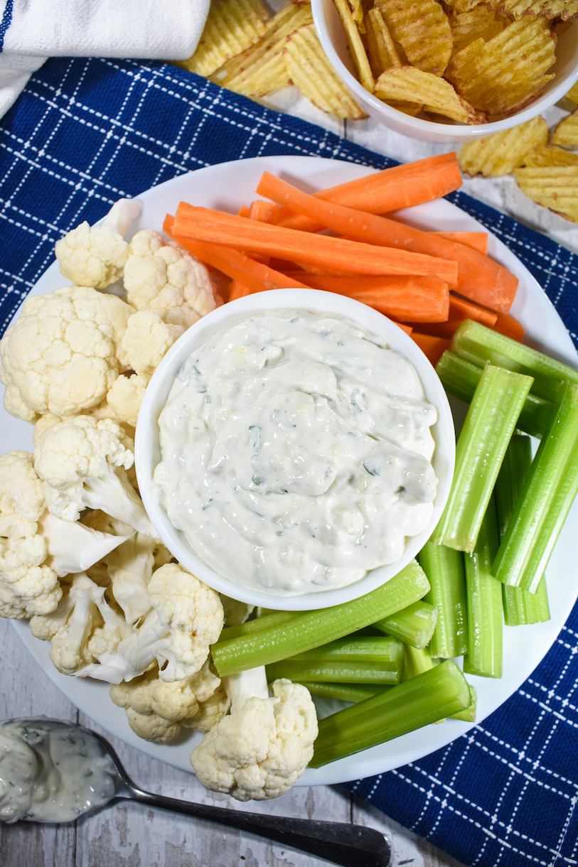 Bowl of blue cheese dip surrounded by raw vegetables