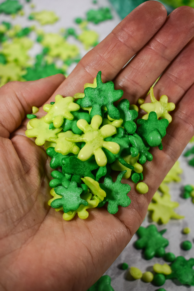 Hand holding a handful of green shamrock sprinkles