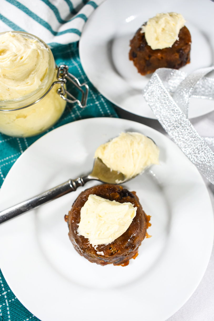 Christmas puddings topped with brandy butter