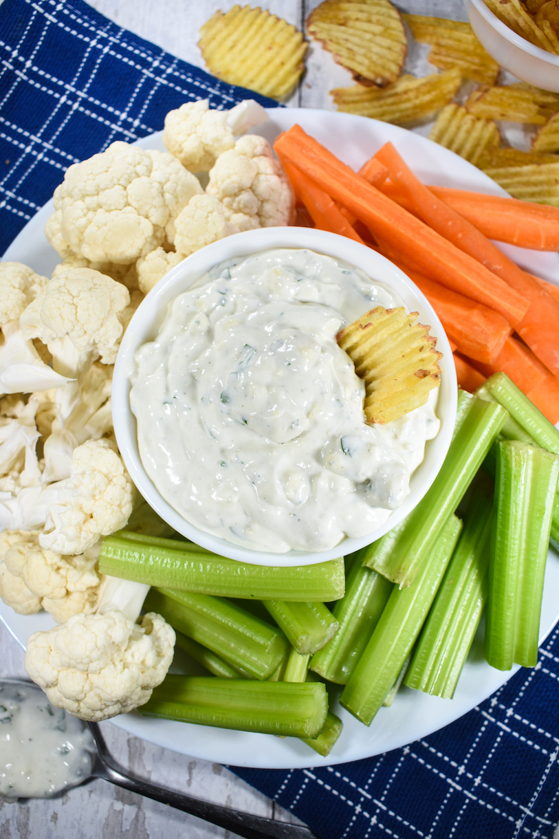 A chip dipped in blue cheese dip