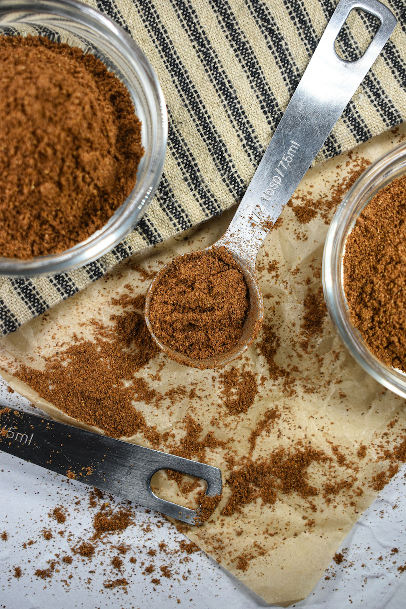 teaspoons of mixed spice on a sheet of parchment