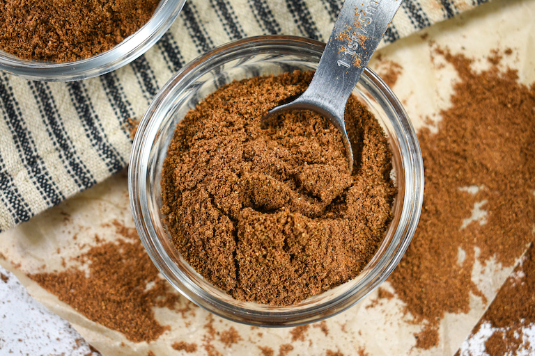 A dish of homemade mixed spice with a spoon