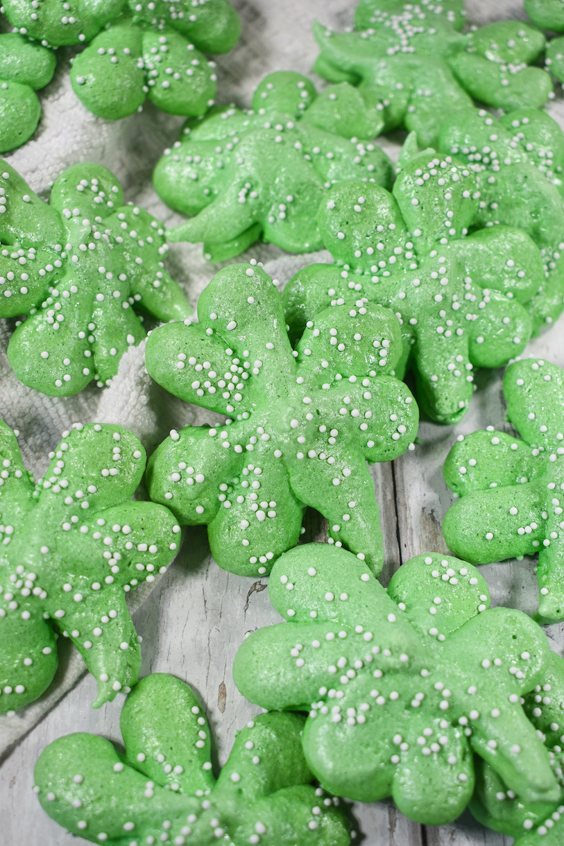 Shamrock meringue kisses on a white surface