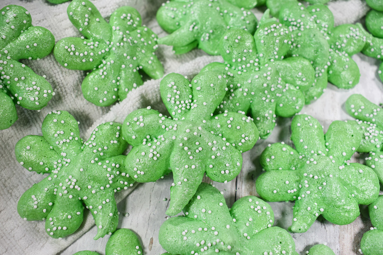 Shamrock cookies on a white surface