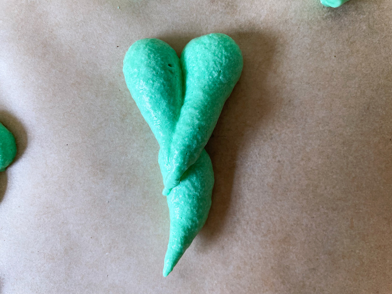 Piping shamrock meringue cookies