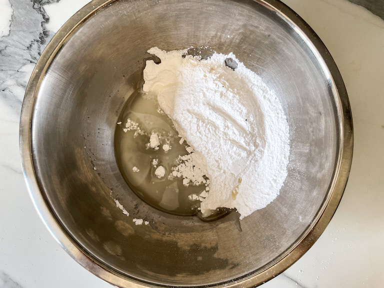 Sprinkle recipe ingredients in a metal bowl