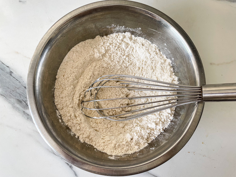 Flour in a bowl with a whisk