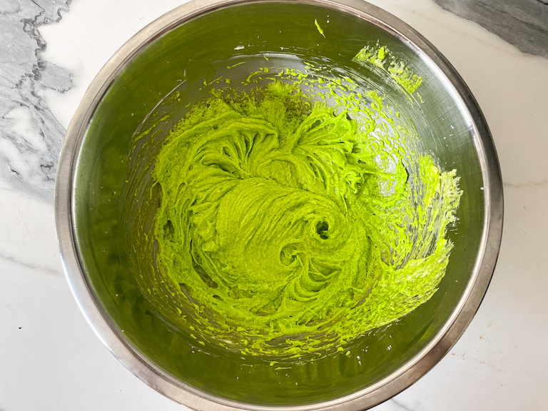 Green cookie batter in a bowl