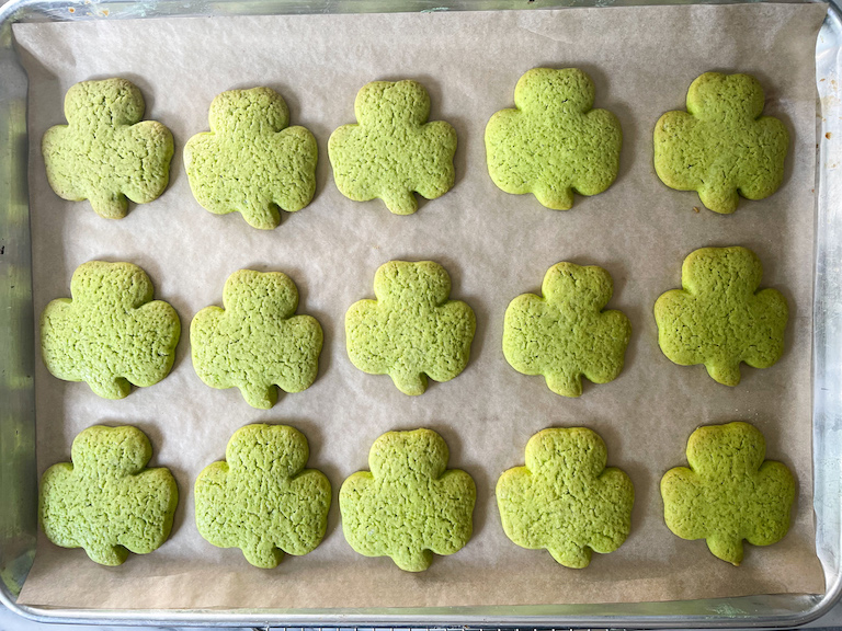 Green shamrock shaped cookies on a tray