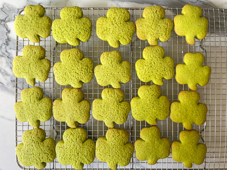 Green shamrock cookies on a tray