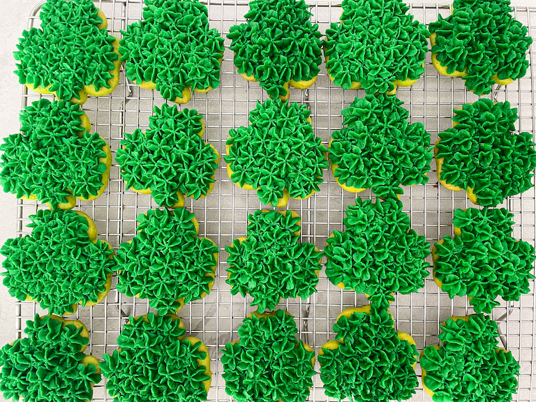 Green shamrock cookies decorated with buttercream