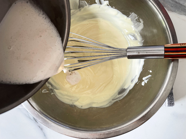 Pouring coconut milk into melted white chocolate