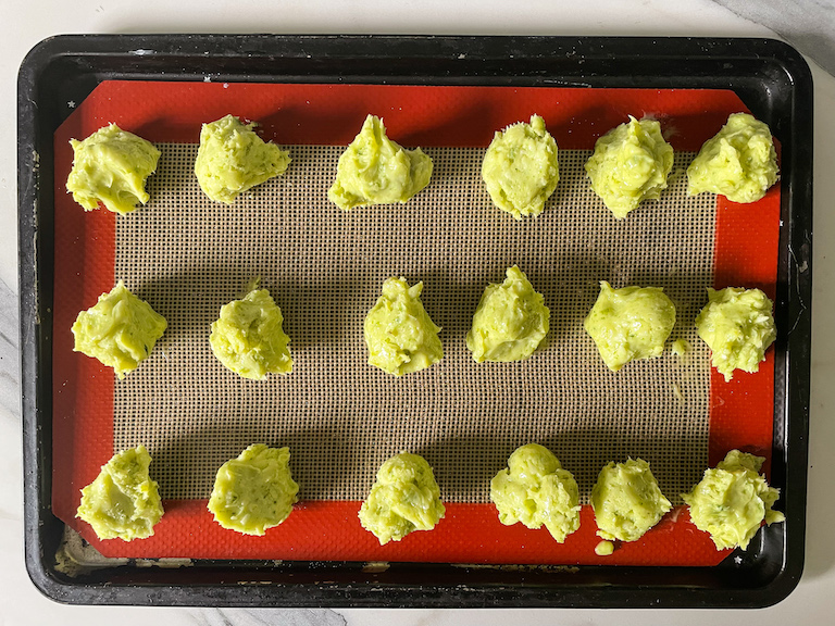 Balls of green ganache on a tray