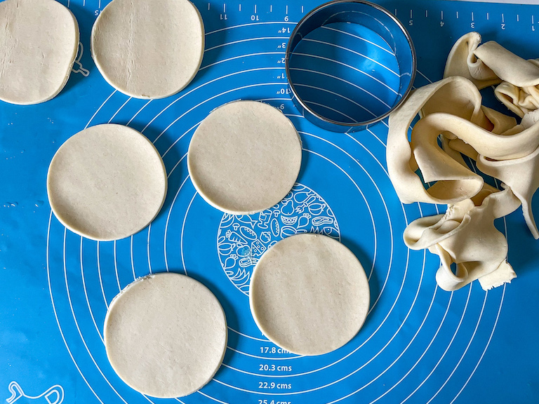 Discs of pastry on a rolling mat