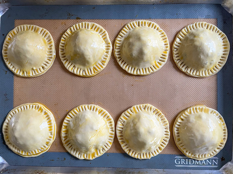 Unbaked hand pies arranged on a tray