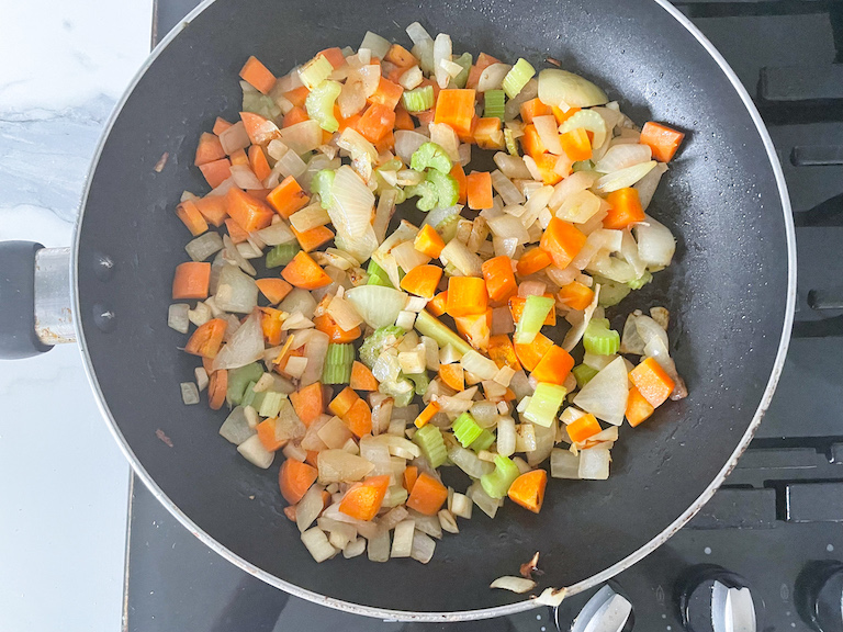 Cooked pot pie vegetables in a pan
