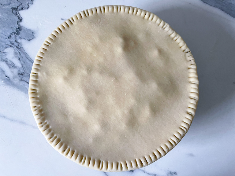 Unbaked pot pie with fork crimped edges