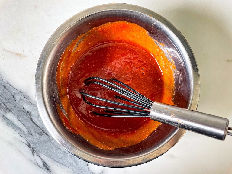 Sweet chili sauce in a bowl with a whisk