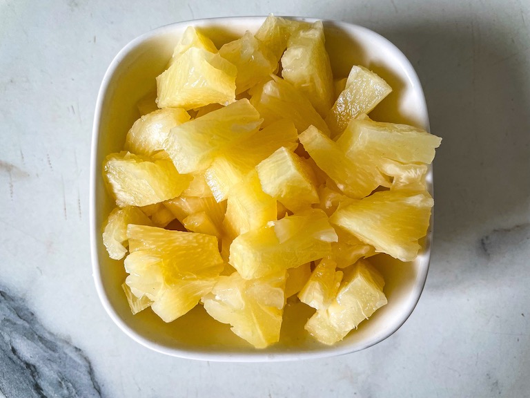 A bowl of chopped pineapple