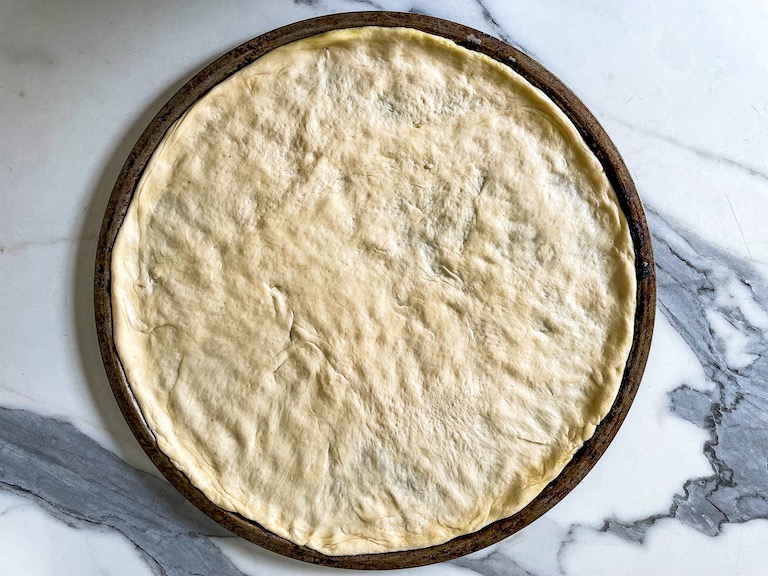 Pizza dough on a pizza pan