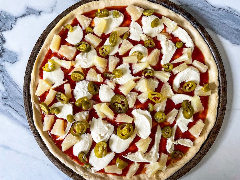 Pizza with pineapple, jalapeno peppers, and mozzarella