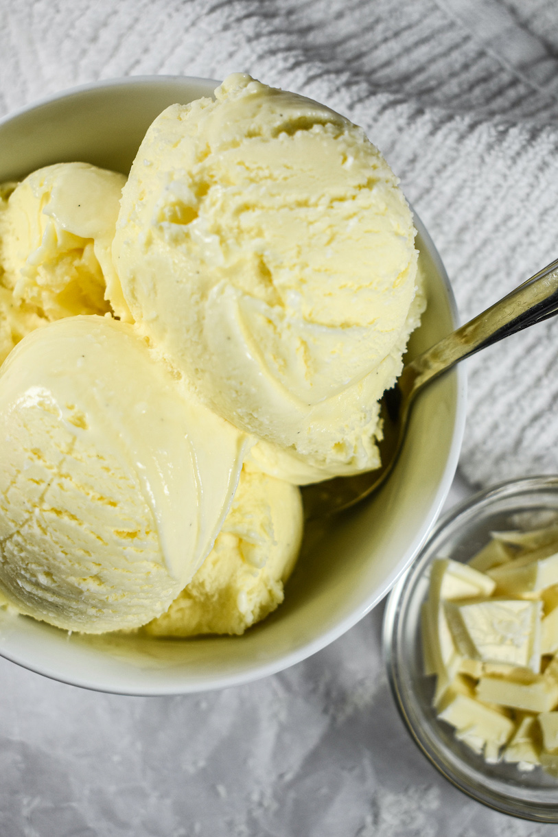 A bowl of white chocolate coconut ice cream and a white tea towel