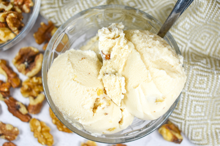 Looking down at two scoops of maple walnut ice cream in a dish