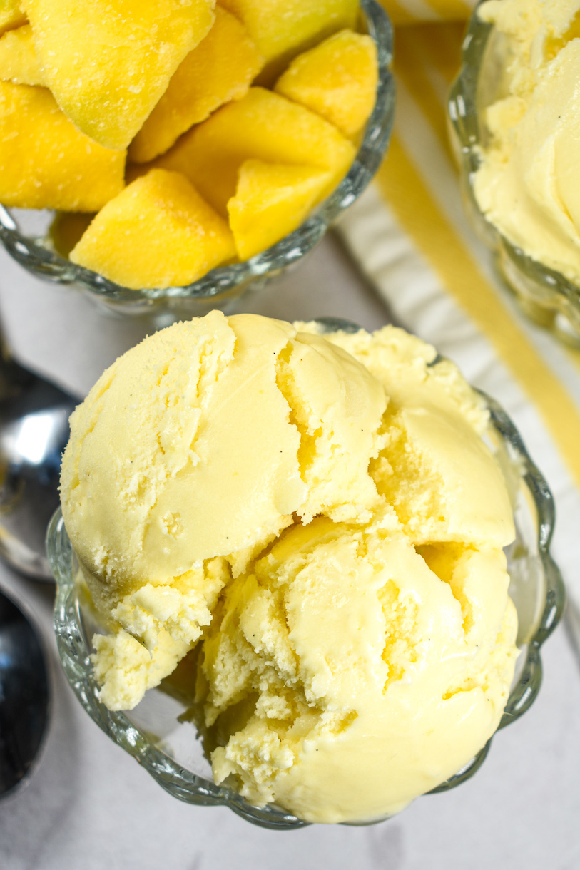 A dish of chopped mango and a dish of mango ice cream