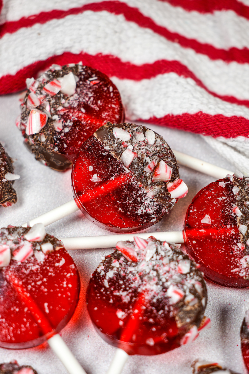 Homemade Christmas lollipops and a red and white striped towel