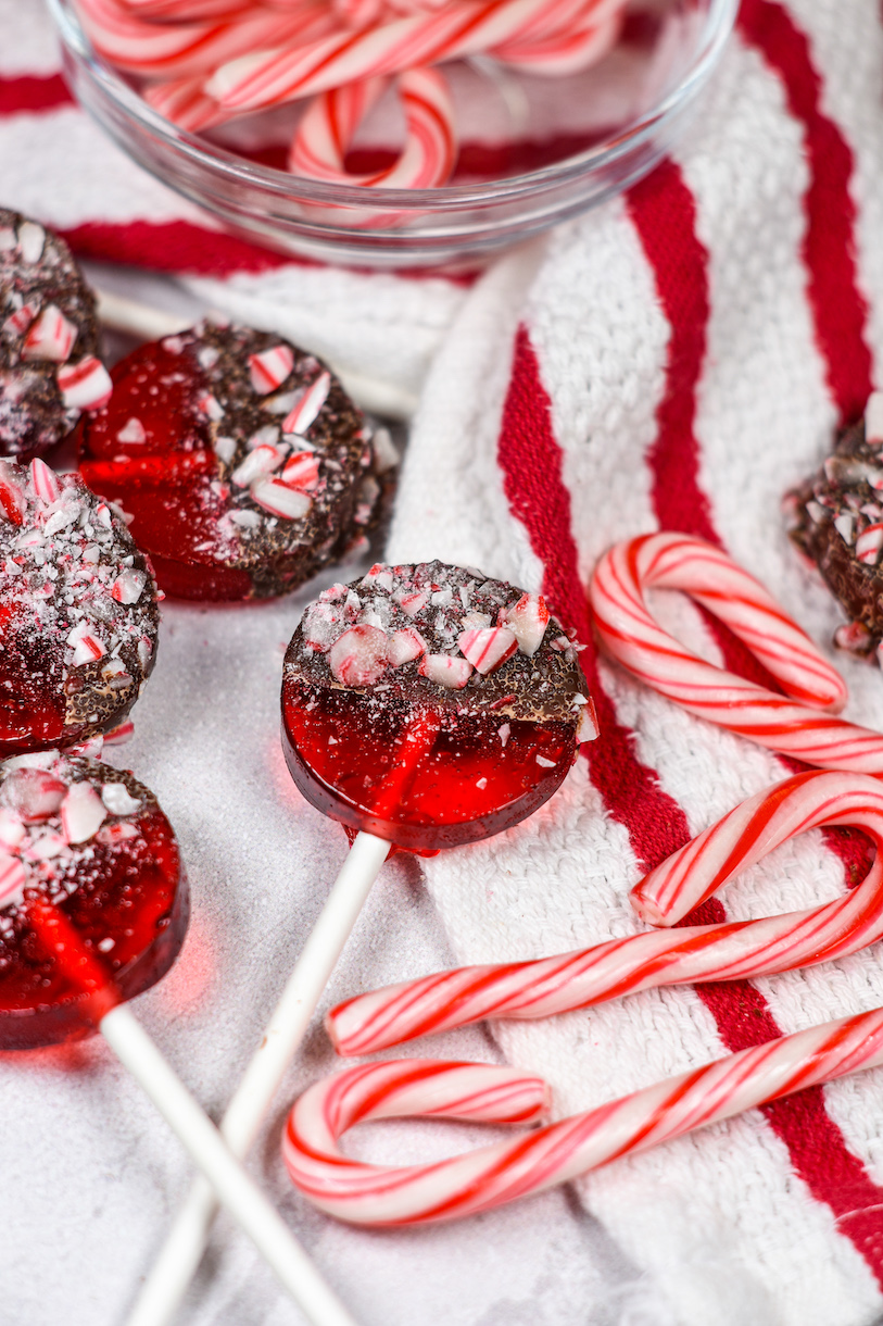 Christmas lollipops arranged on a striped tea towel