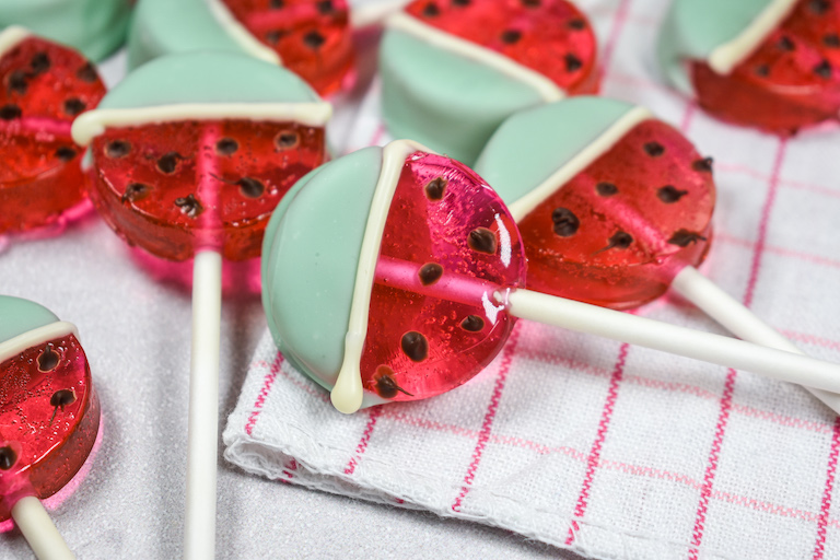 Watermelon lollipops on a plaid towel