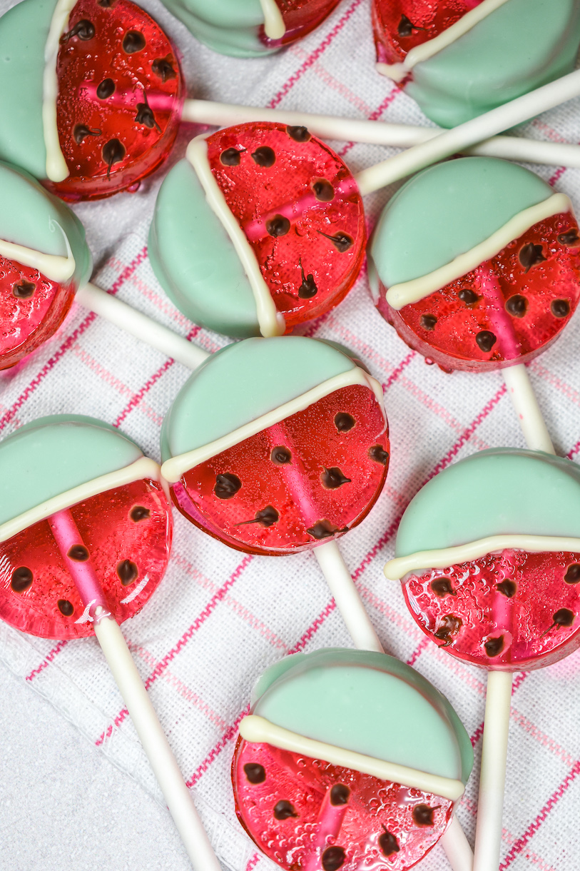 Watermelon lollipops on a white and pink plaid towel