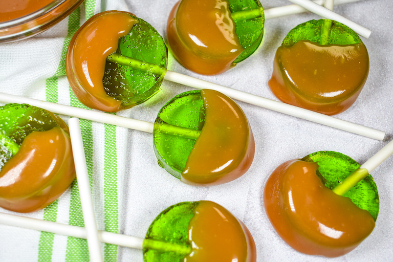 Green apple lollipops dipped in melted Kraft caramels