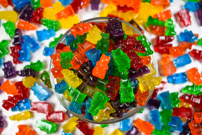 Rainbow gummy bears in a glass dish