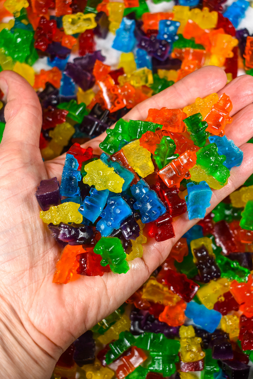 Hand holding homemade gummy bears from Jello