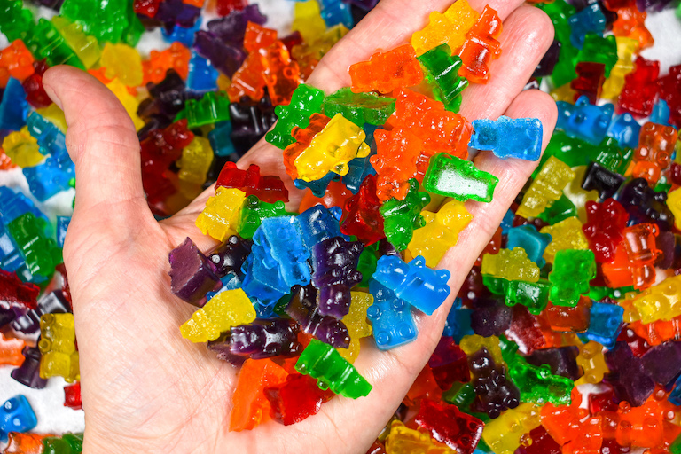 Hand holding a handful of gummy bears