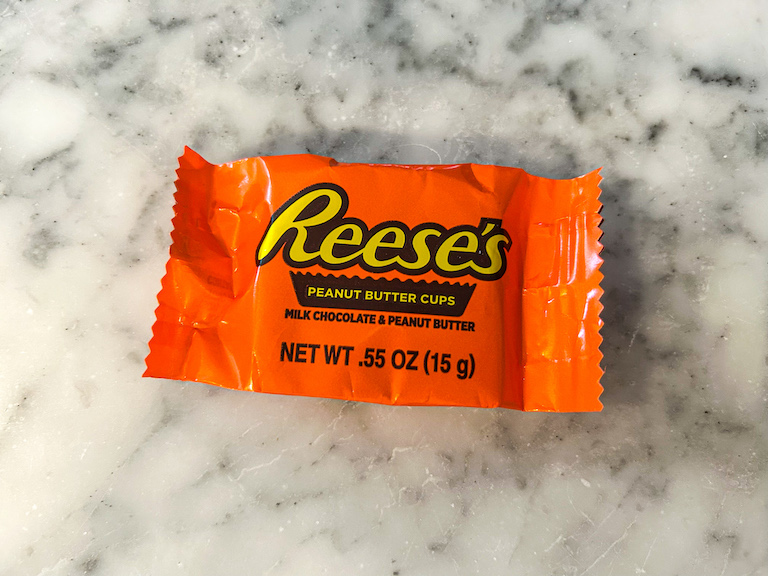 A Reese's cup in an orange wrapper