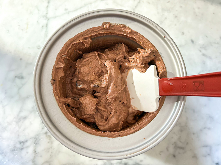 A bowl of homemade ice cream with a spatula